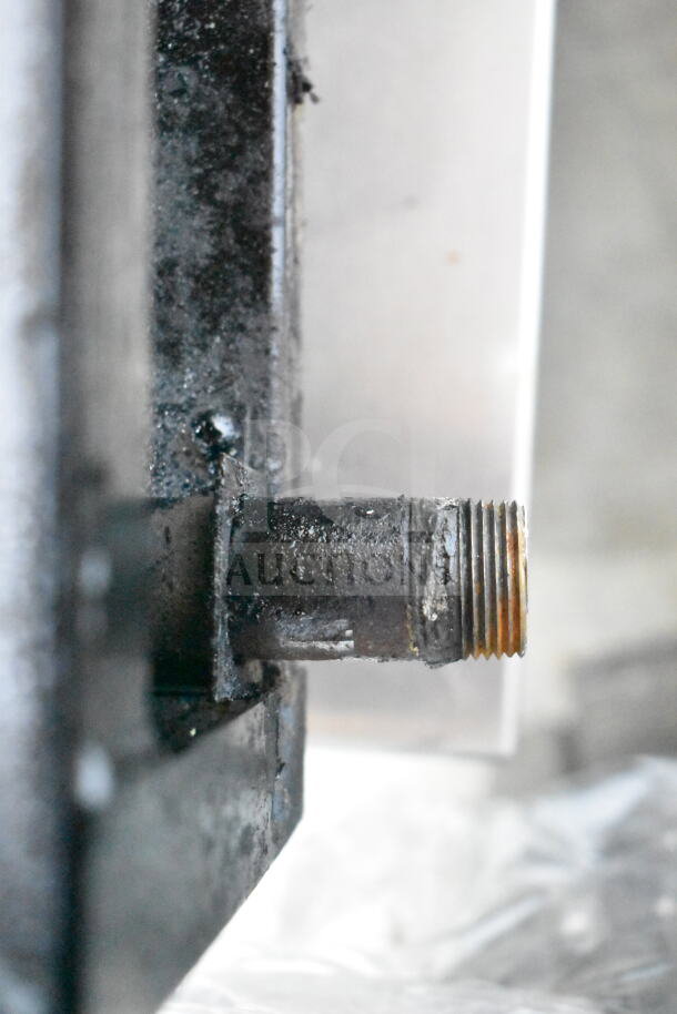 Close-up of a gas pipe connection on a Star Max Commercial Countertop 6 Burner Range, showing signs of wear and residue.