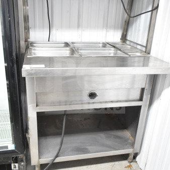 Commercial electric powered steam table with sneeze guard, 120/208 volts, 1 phase. Stainless steel construction, three-pan capacity.