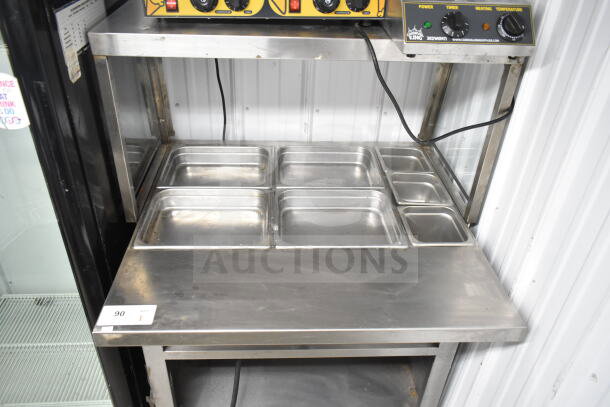 Commercial electric-powered steam table with sneeze guard, stainless steel construction, 120/208V, 1 phase.