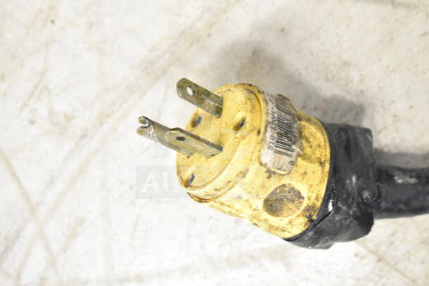 Commercial electric steam table plug, 120/208 Volts, 1 Phase, shows signs of wear, yellow with labeling.