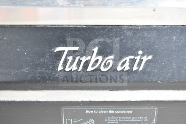Turbo Air TOM-50M commercial merchandiser, 120 Volts, visible logo and condenser cleaning instructions panel.