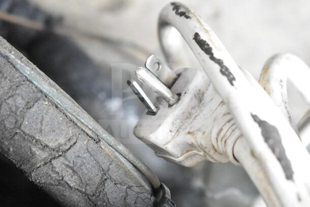 Turbo Air TOM-50M plug detail showing wear and discoloration, connected to black, cracked cable, indicating used condition.