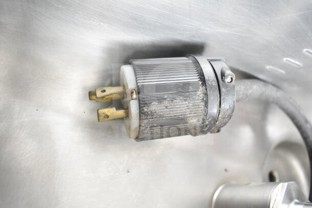Close-up of a power plug for a Taylor C709-33 commercial soft serve machine, showing minor wear and dust.