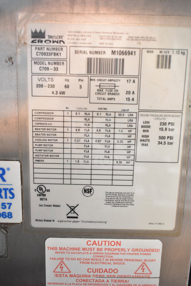 Taylor C709-33 commercial ice cream machine label shows model, voltage 208-230, 3 phase, with caution notes and specs.