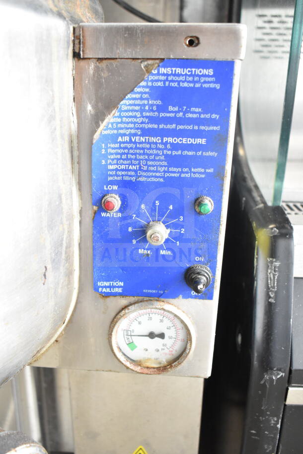 Cleveland KGL-40 steam kettle control panel with instructions and gauge, showing wear, used for commercial cooking.