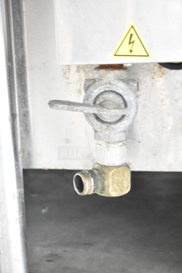 Cleveland KGL-40 Commercial Steam Kettle detail showing valve and electrical warning label, indicating heavy-duty use.