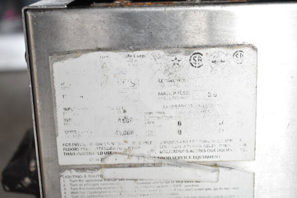 Radiance commercial countertop gas-powered 2 burner range with visible wear. Labels indicate model and safety instructions.