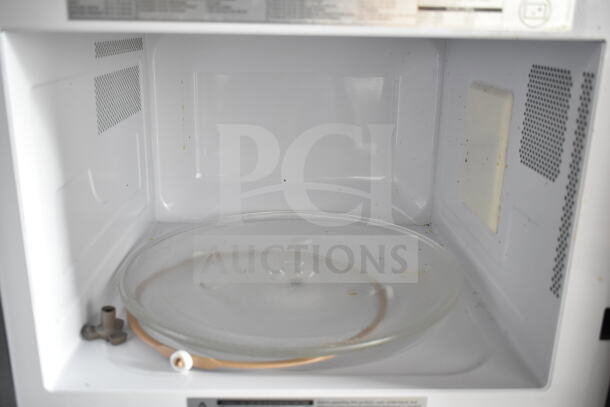 2024 Toshiba EM131A5C-BS Commercial Microwave Oven. Interior view, clean condition, glass turntable visible. 120V, 1 Phase.