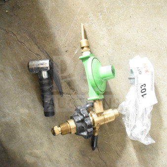 Three various tools on concrete, including a green gas regulator, with auction tag labeled 103. Items in used condition.