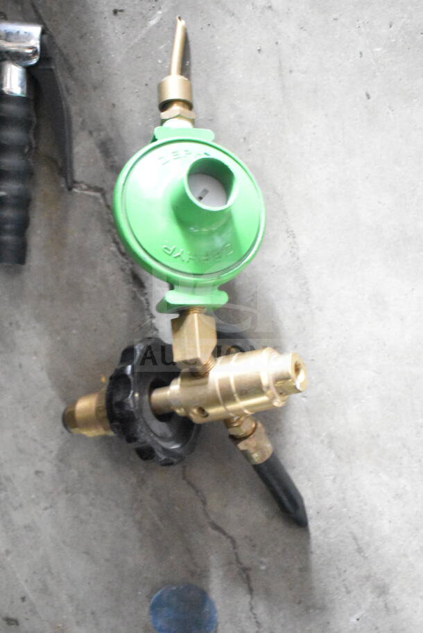Brass gas regulator with green cap, labeled "Zephyr," in good condition, alongside a black grip handle.