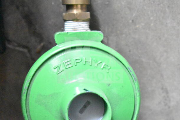 Green Zephyr device with brass fitting, marked "Zephyr," appears functional. Ideal for industrial or mechanical use.