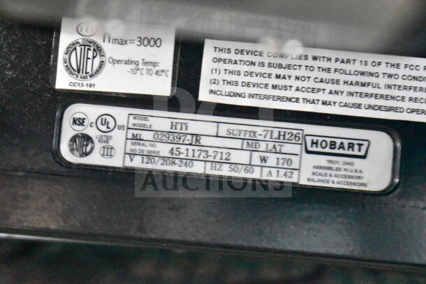 2017 Hobart HTi-7LH26 commercial scale label showing model details, volt range (120/208-240V), and UL certification.