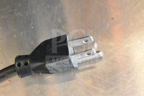 Close-up of a black power plug for the 2017 Hobart HTi-7LH26 commercial food portioning scale.