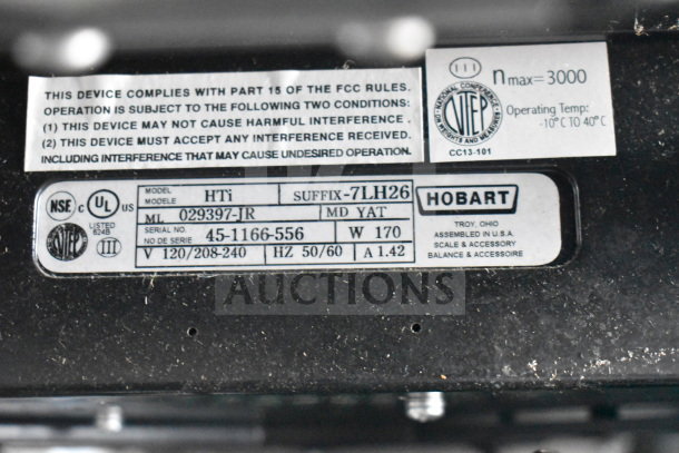 2017 Hobart HTi-7LH26 commercial scale label showing model, serial number, voltage details, and compliance information.