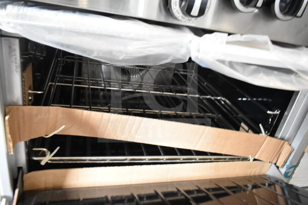 Brand new Garland G60-6G24CC range interior with factory packaging. Includes 24" griddle and 2 convection ovens.