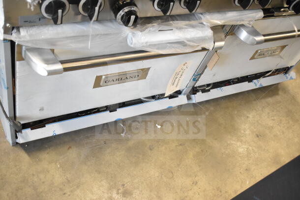 Brand new Garland G60-6G24CC 60" LP range, 6 burners, 24" griddle, 2 convection ovens, 280,000 BTU, slight scratches.