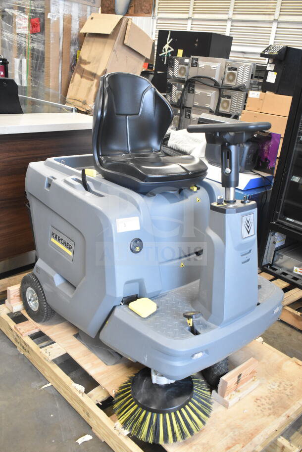 Brand new Karcher KM 85/50 R BP 24" cordless ride-on sweeper, 13.2-gallon, with one side broom, minor scratches visible.