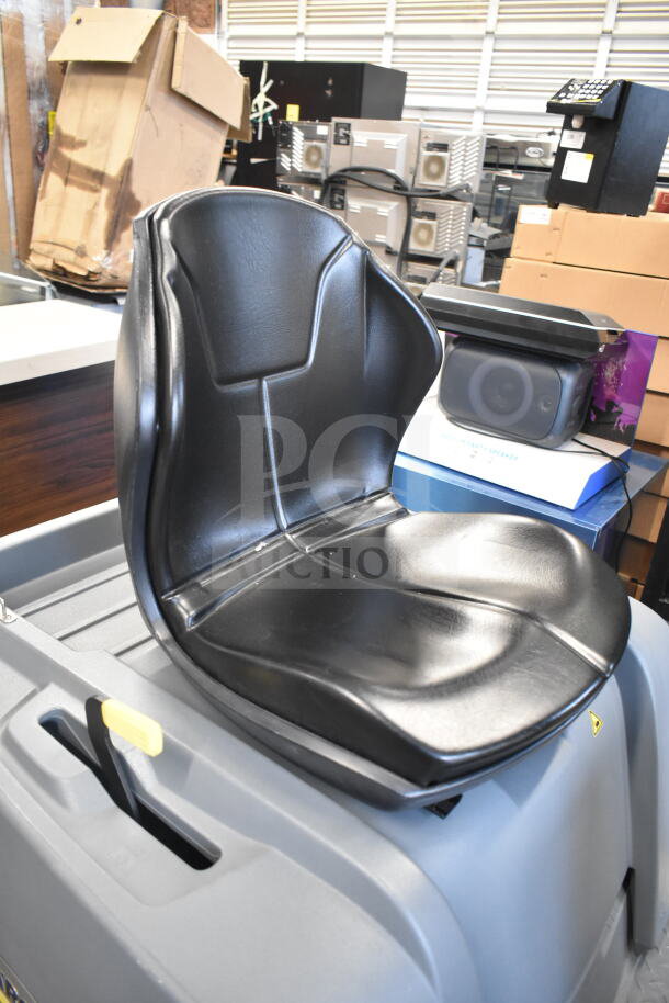 Karcher KM 85/50 R BP 24" ride-on sweeper, new scratch and dent condition, features a comfortable black seat.