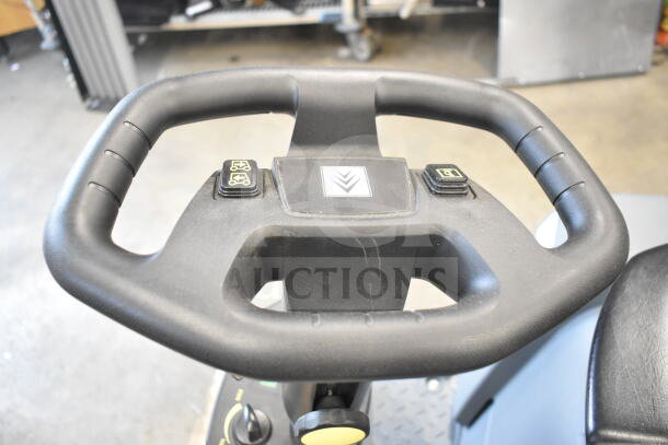 Steering wheel and controls of a Karcher KM 85/50 R BP ride-on sweeper, showing condition and operational buttons.