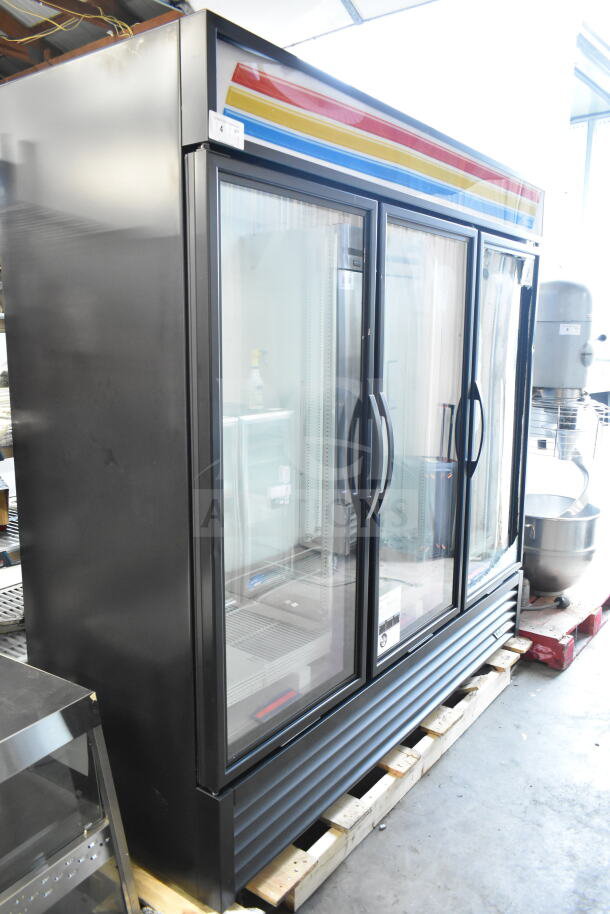 Brand new True GDM-72-HC 3-door reach-in cooler, commercial-grade. Note visible broken glass. 115 volts, 1 phase.