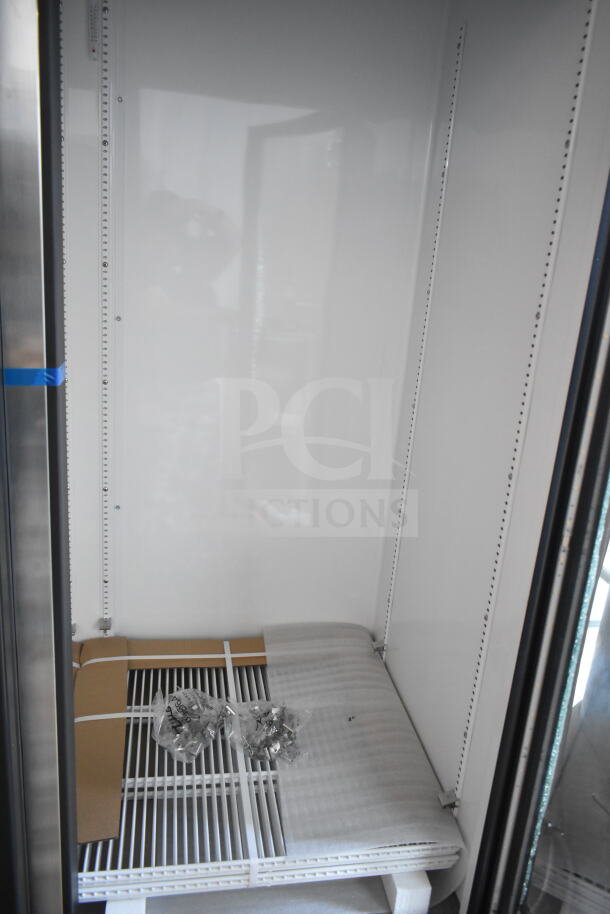 BRAND NEW True GDM-72-HC cooler, 3-door, scratch and dent, broken glass visible. Includes shelving and 115 volts, 1 phase.