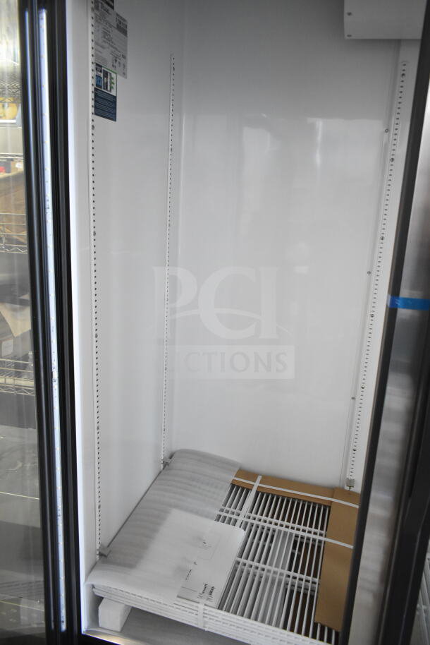 Brand new True GDM-72-HC 3-door cooler merchandiser, commercial grade, 115 volts, shown with broken glass and tags.