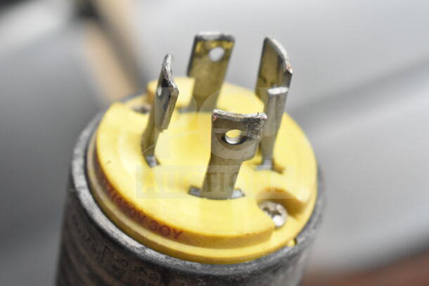 Close-up of a Hobart M-802 mixer plug with visible yellow connector and metal prongs, indicating 200V, 3 Phase connectivity.