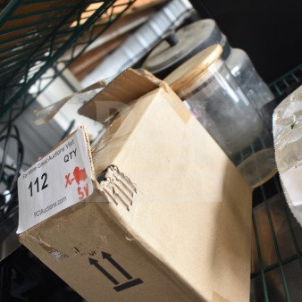 Cardboard box with auction label on shelf, containing 5 various items including Taylor thermometers and a container. Box is slightly damaged.