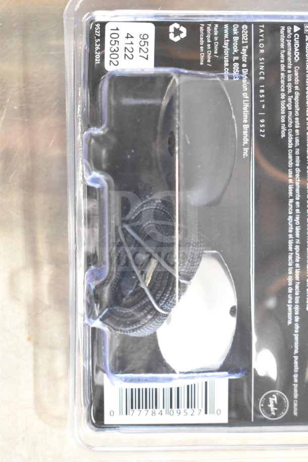 Packaging with Taylor thermometers, product code 9527, visible label in black and white container.