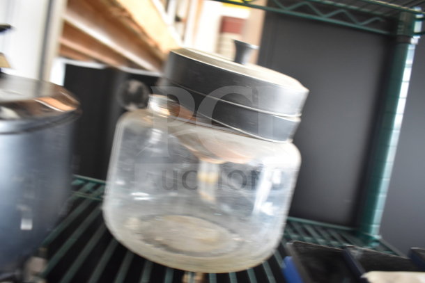 Clear container with black lid, part of a lot featuring Taylor thermometers. Good condition, ideal for collection or resale.