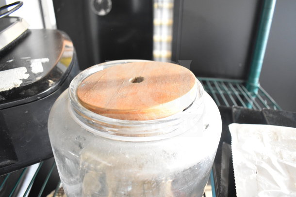 Glass container with wooden lid, visible wear; part of auction lot including Taylor thermometers.