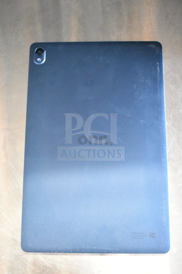 Onn tablet, black back, visible camera, branding, and FCC markings, gently used condition. Lot includes 7 tablets.