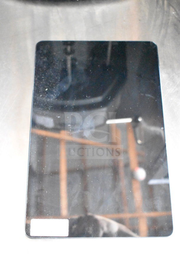 Seven Onn tablets on display, various models, reflective screens, slight smudges, auction bid multiplier noted.