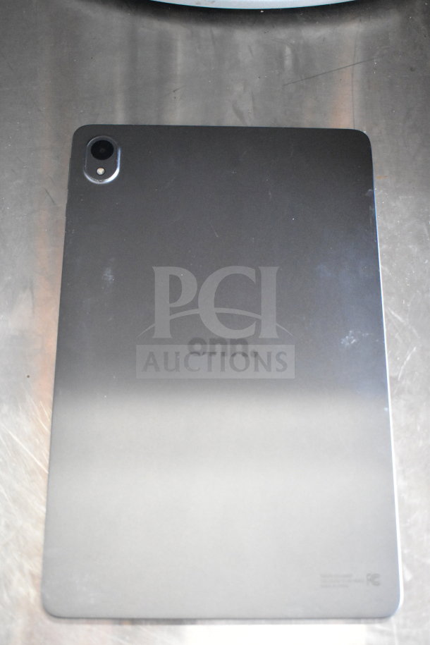 Seven Onn tablets, back view, black finish, showing logo and camera. Condition appears gently used.