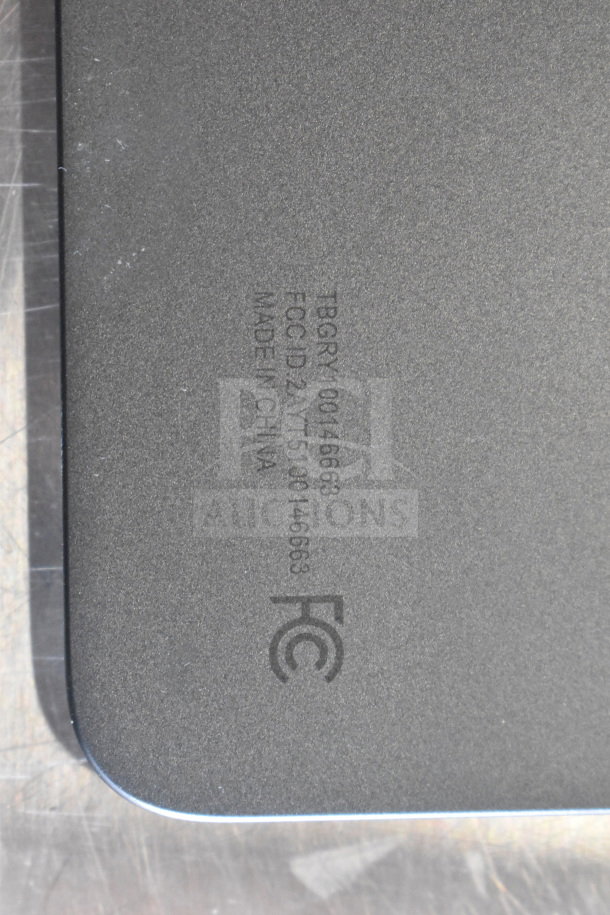 Back view of Onn tablet showing FCC ID: 2AYYT5100146663, manufactured in China. Smooth grey surface detail.