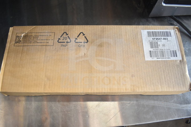 Cardboard box containing a Globe meat slicer blade remover and a computer keyboard. Labels indicate model KU-1156, made in China.