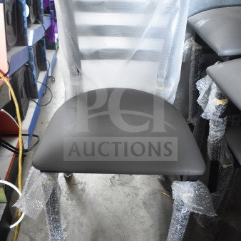 5 brand new Lancaster Table & Seating ladder back chairs, dining height, with dark gray vinyl padded seats, wrapped in protective material.