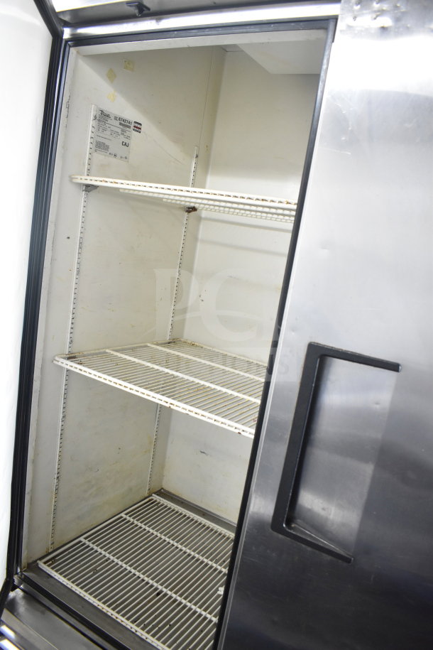 True T-49 commercial 2 door reach-in cooler, 115 volts, 1 phase, features shelves, used condition, manufacturer's label visible.