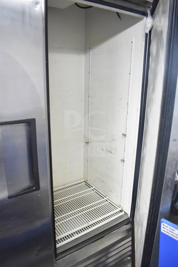 True T-49 Commercial Cooler, 2-door, interior view. Steel exterior, adjustable shelving, 115 volts, 1 phase. Used condition.