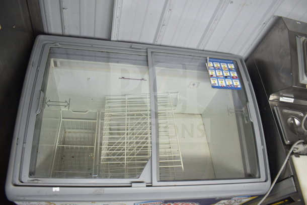 Commercial Freezer Merchandiser, 115 Volts, 1 Phase, sliding glass doors, wire shelves, used condition, visible pricing cards.
