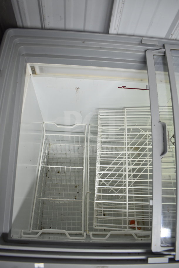 Commercial freezer merchandiser, 115V, 1 phase, sliding glass door, interior wire baskets, used condition.