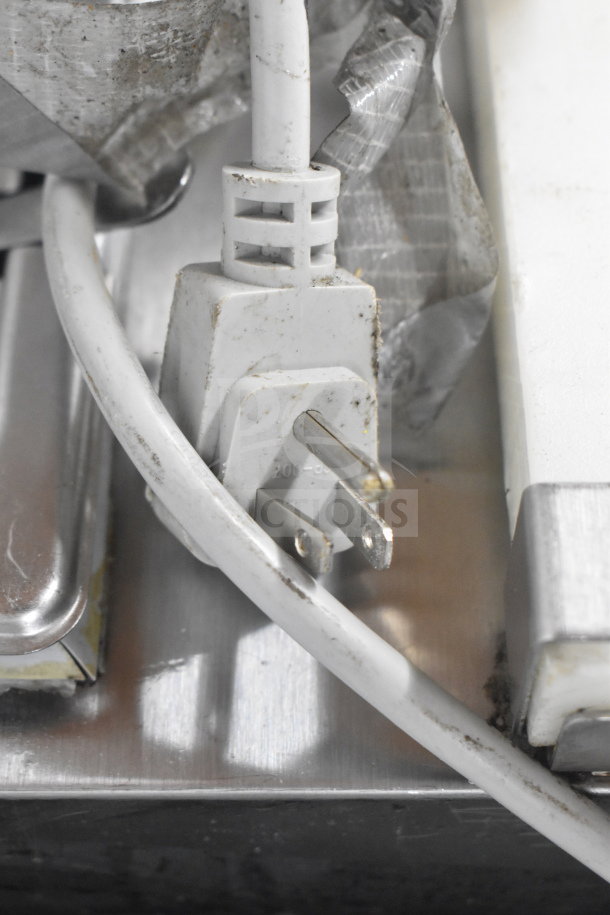 Close-up of the power plug and cord for a commercial freezer merchandiser. 115 volts, 1 phase. Showing signs of wear.