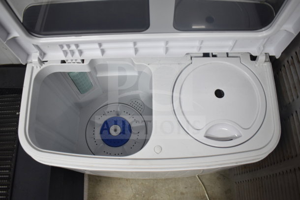 H01GN001 washing machine, white, top-loading, 110 volts, 1 phase, visible dual compartments, excellent condition.