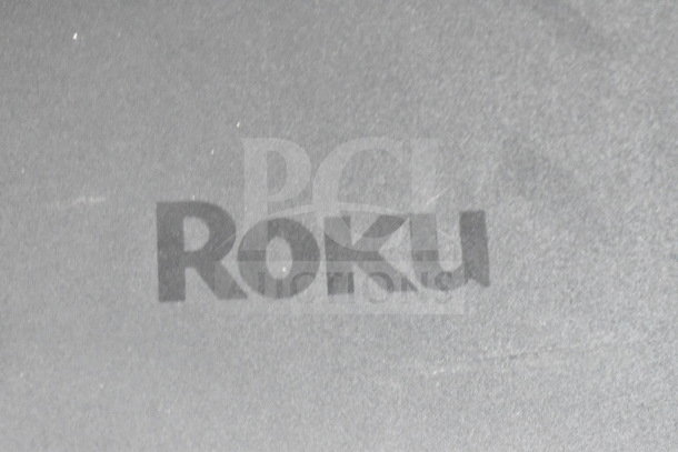 Onn 100002420 Roku Wireless Subwoofer, black, minimal wear, features Roku logo prominently on top surface.