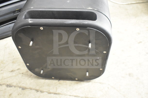 Onn 100002420 Roku Wireless Subwoofer, black, showing bottom panel with visible screws and connectors, in used condition.