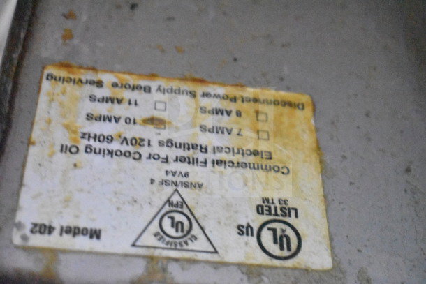 Frontline 402 Commercial Oil Caddy on casters. Features UL listing, 120V, 1 Phase. Label shows amperage options. Signs of wear.
