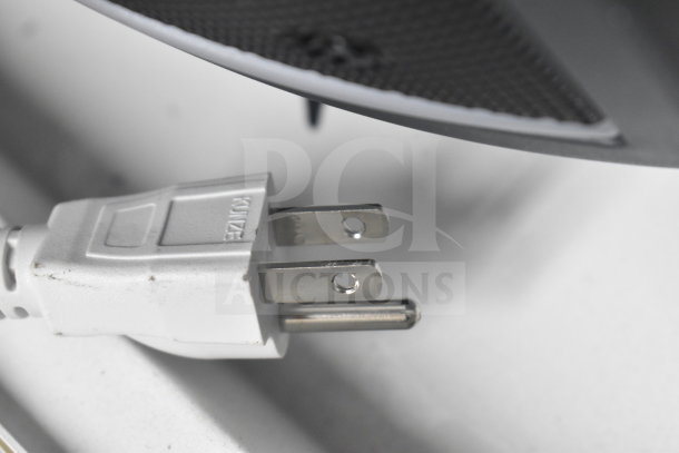 Power plug and partial view of speaker in store display, featuring Ion Party Boom Plus Speaker, showing plug detail.