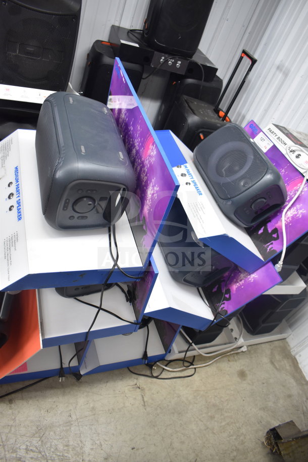 6 Onn Medium Party Speakers in display boxes, showcasing features. Ideal for parties. Visible cables, new condition.
