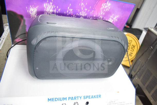 Onn medium party speaker on display, featuring a mesh grille, sleek design, and visible label reading "Medium Party Speaker."