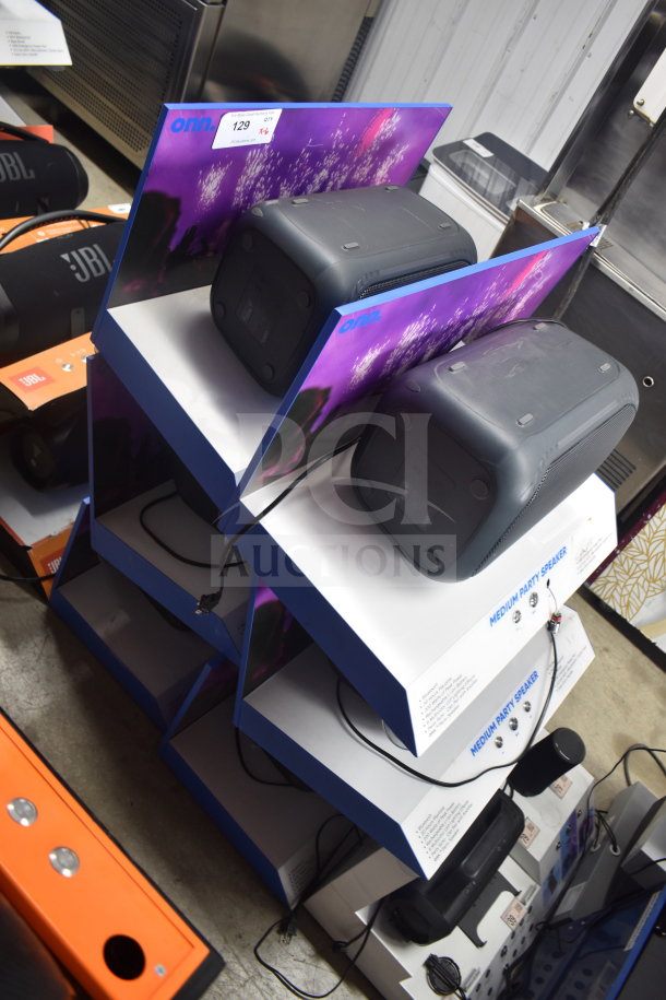 Onn Medium Party Speaker display, showcasing six units. Each is boxed with bold graphics. Price tag visible. Suitable for store showcase.